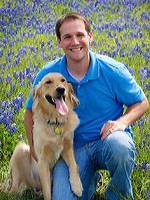 Daryl with his dog Bentley in a field of bluebonnets.