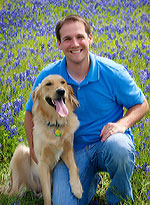 Daryl with his dog Bentley in a field of bluebonnets.
