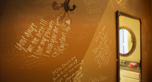 Graduating Seniors have filled a wall with written notes about their portrait sessions at G. Patterson Studio.