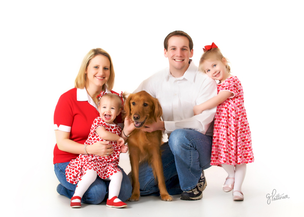 Family of four loving their dog Abby. Photo by Greg Patterson.
