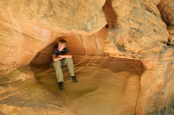 Nathan Patterson sits in the shelter of a rock.