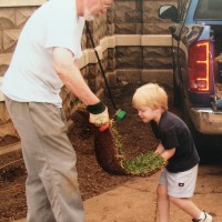 Nathan helping Dad place the grass.
