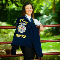 Lacey proudly holding her FFA jacket